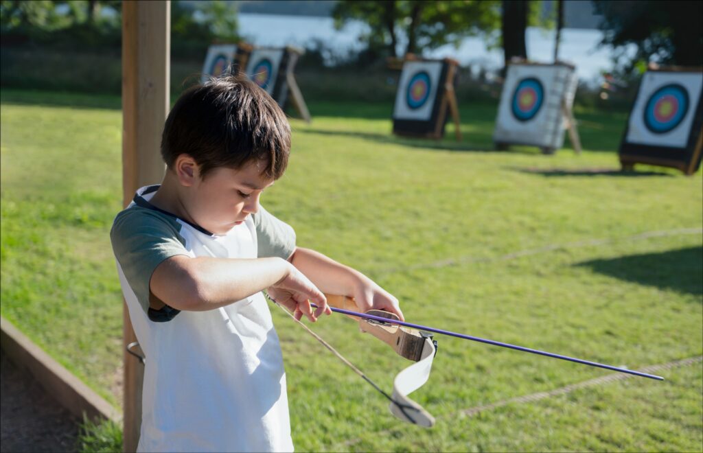 Portrait Young kid practising his archery, Mixed race child doin