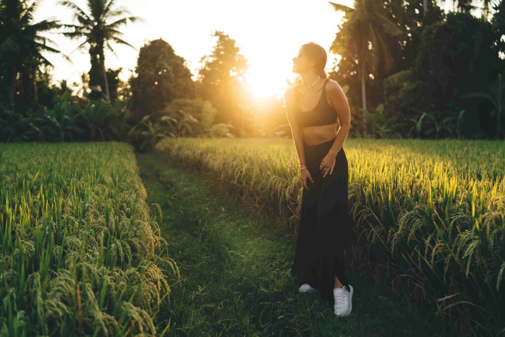 Unrecognizable woman standing among green grass grass