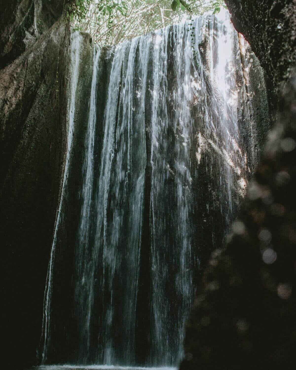 The hidden gem of Tukad Cepung Waterfall surrounded by rock formations in Balis 2 1