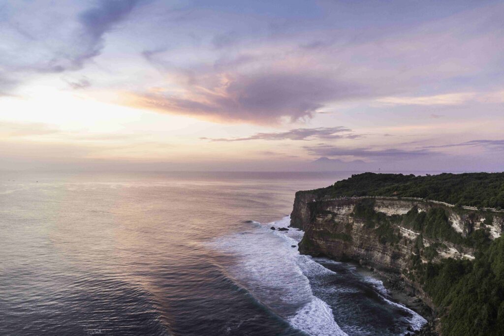 Elevated view of cliffs and sea at sunset, Uluwatu, Bali, Indonesia