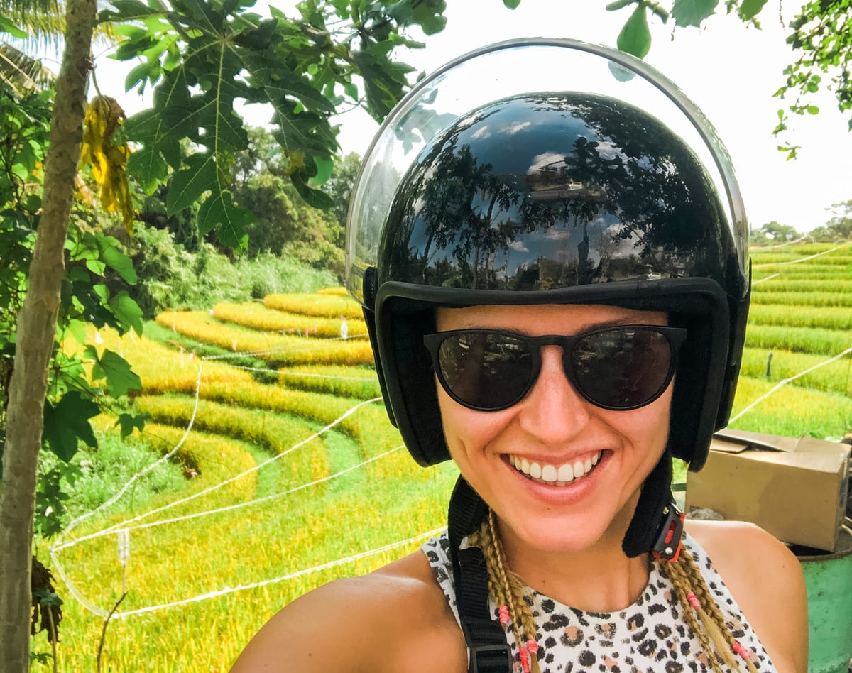 Woman wearing motorbike helmet and smiling