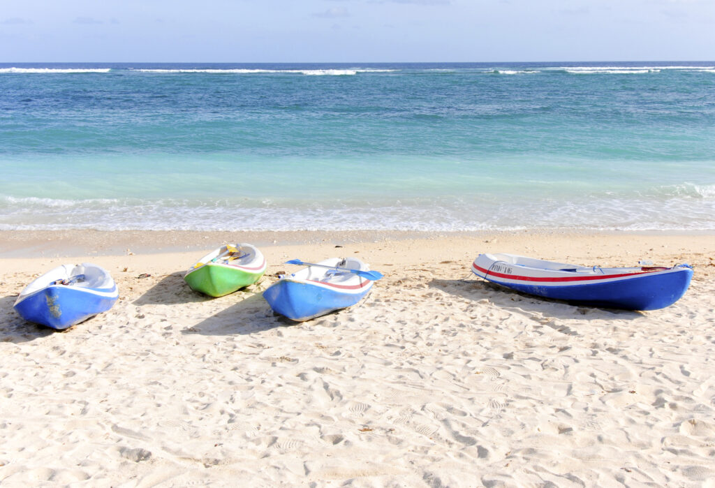 empty kayaks on the sand at pantai pandawa beach 2022 10 03 16 46 54 utc scaled