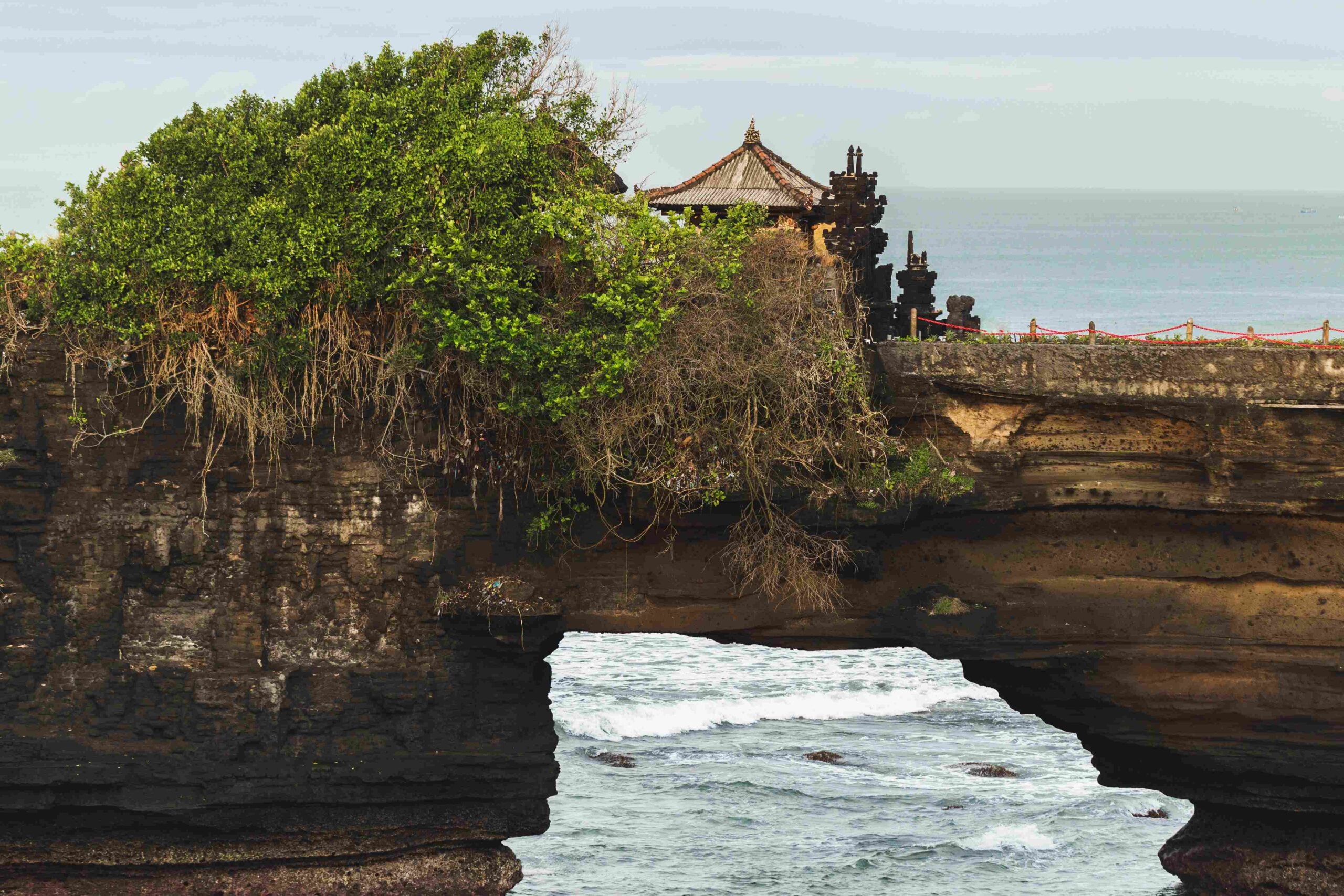 Sacred Balinese temple Tanah Lot Pura Batu Bolong on the edge o