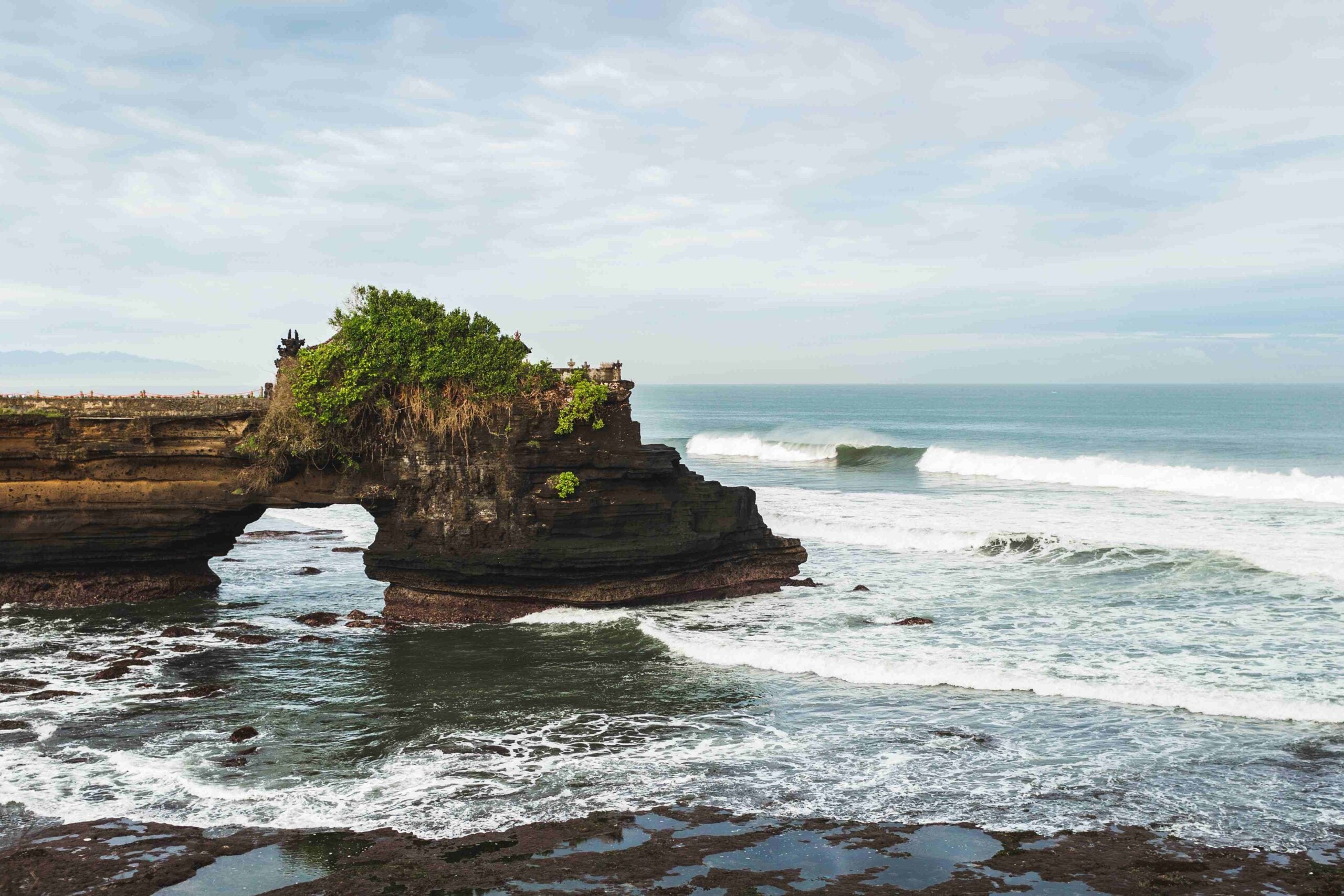 Sacred Balinese temple Tanah Lot Pura Batu Bolong on the edge o
