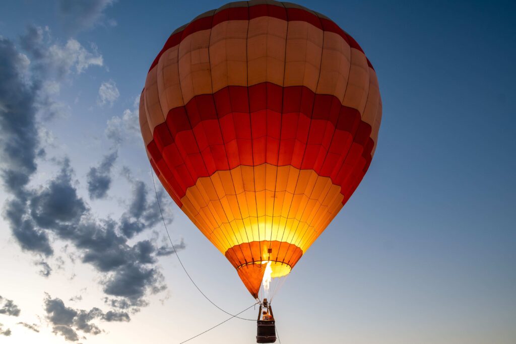 Aerial view of a colorful hot air balloon drifting through the sky