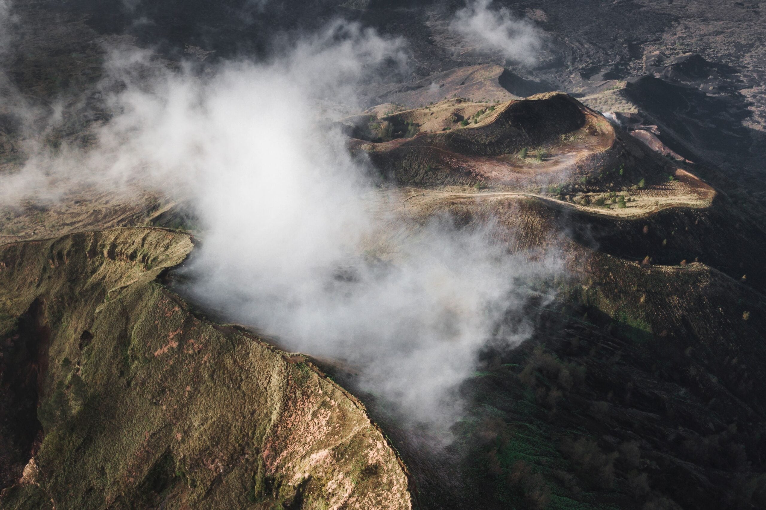 Aerial view of Batur volcano caldera in Bali. Volcanic black tex