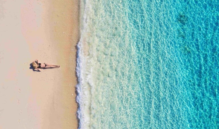 aerial view of a girl on the beach on bali indone 2023 11 27 05 20 54 utc
