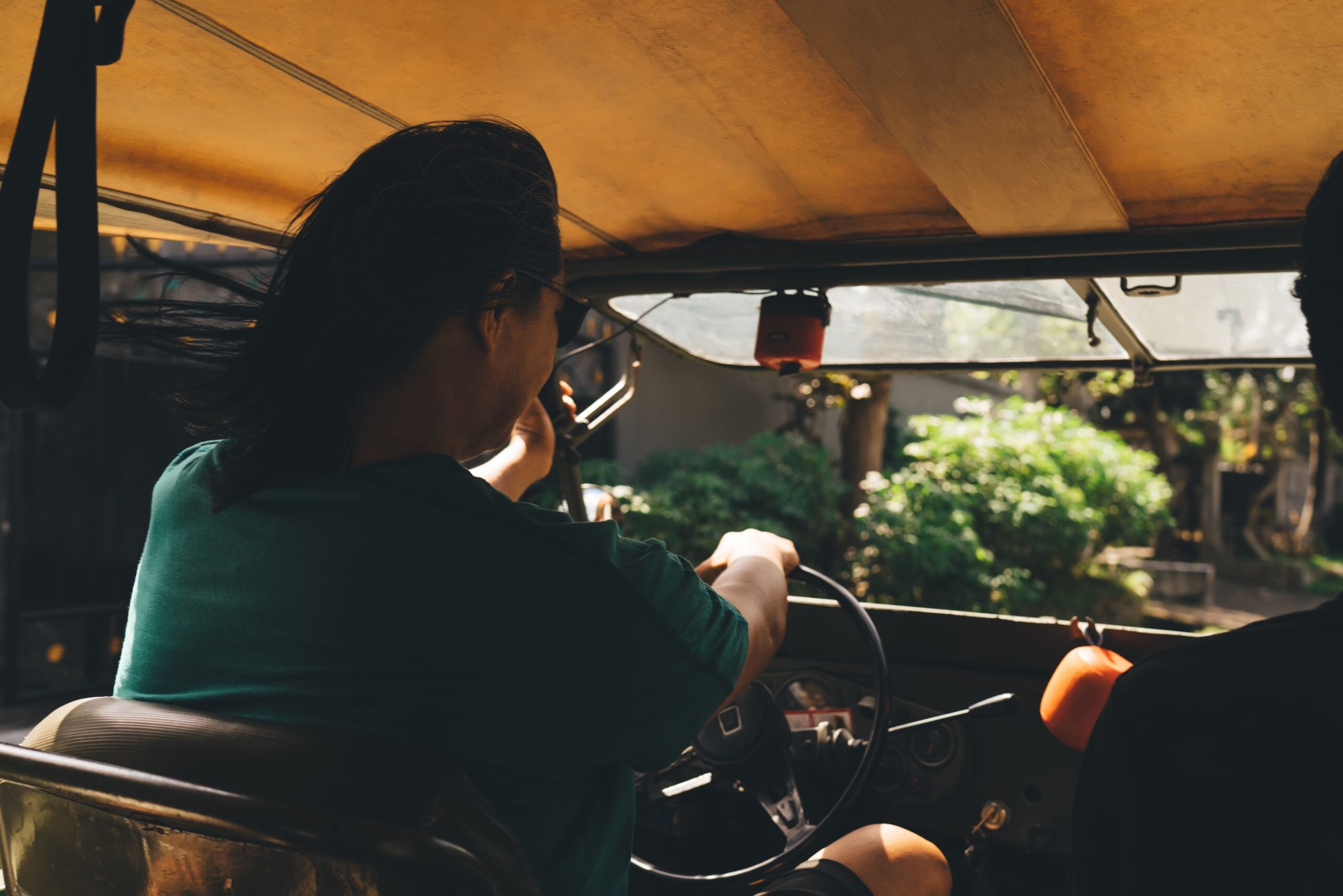 Anonymous driver at steering wheel and riding car in summer