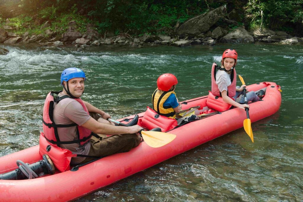 Family starting rafting on a mountain river.
