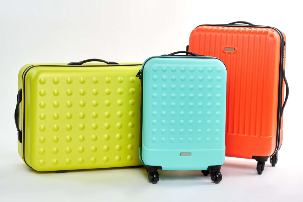 Group of three colorful suitcases.