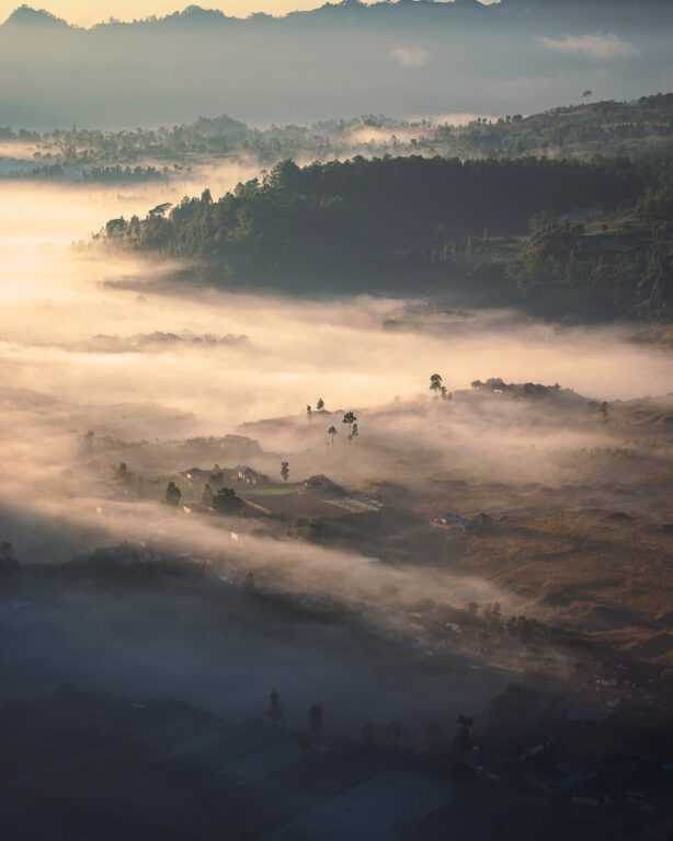 Hills covered in fog under the sunlight during a beautiful sunrise in Pinggan, Bali, Indonesia