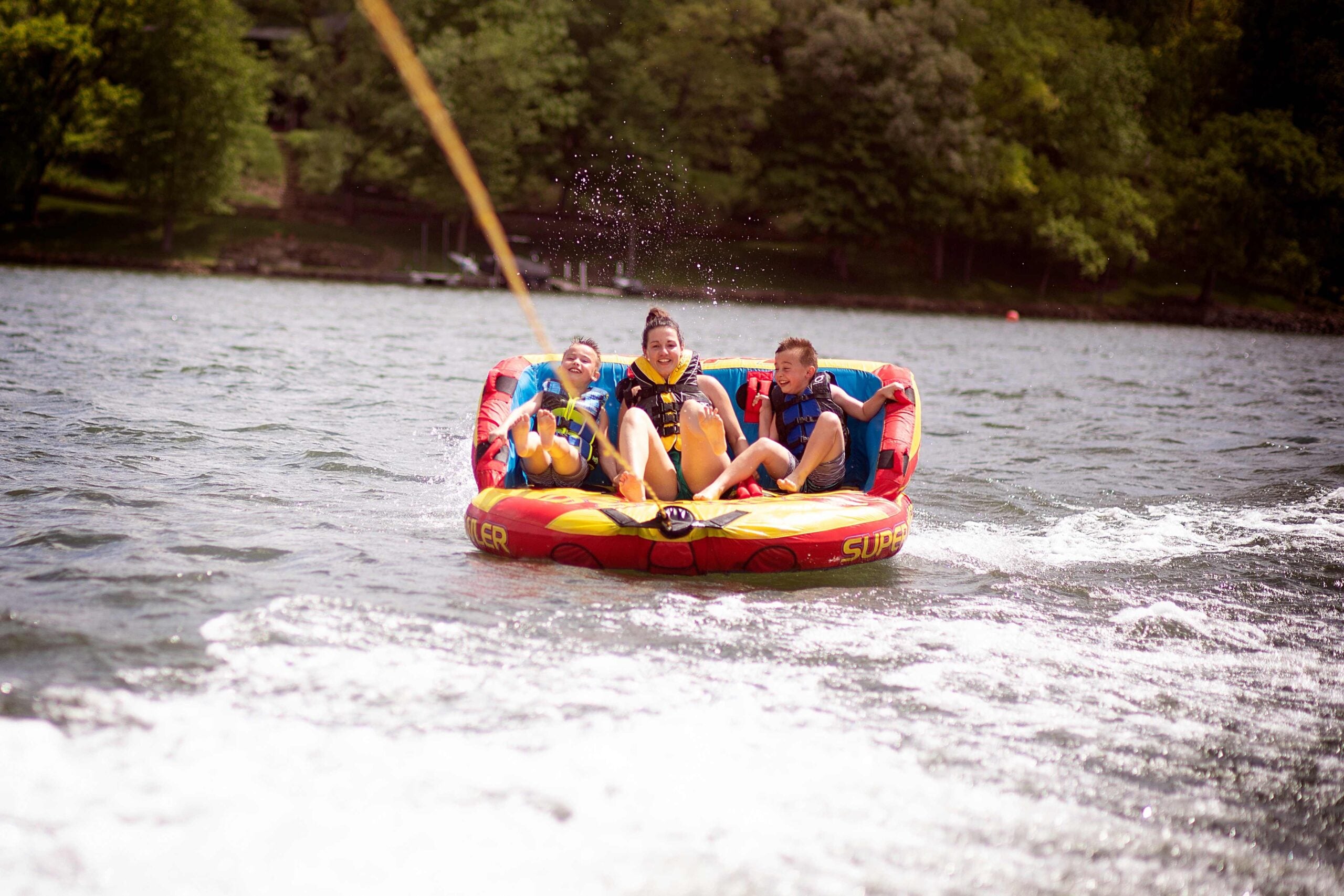 mom and boys water tubing on a lake together famil 2023 11 27 05 33 26 utc
