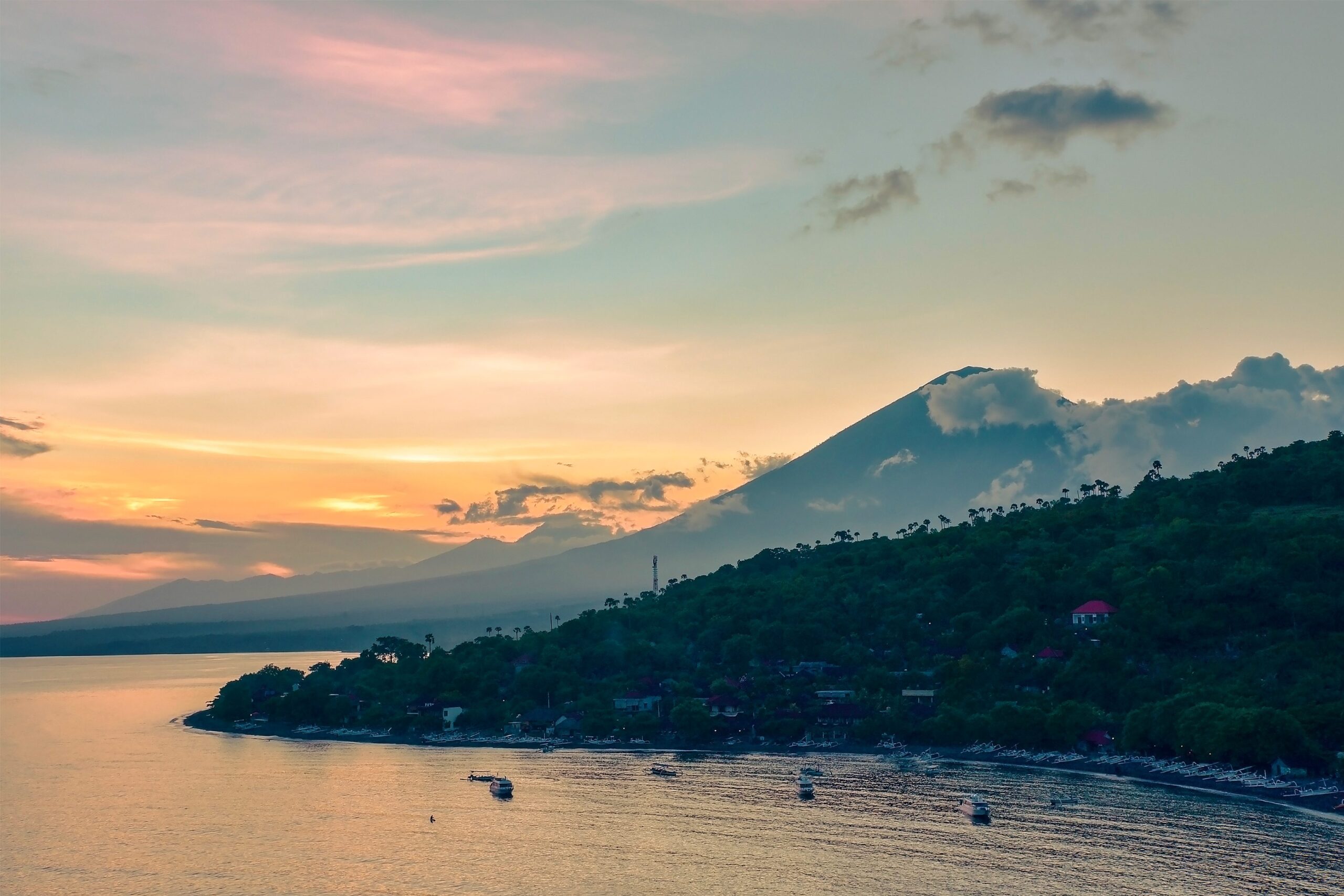 Top view of Amed beach and volcano Agung at sunset. Bali, Indonesia