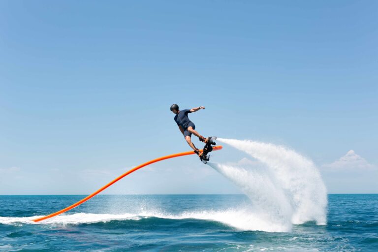 Water extreme sport. The guy is flying at the aquatic flyboard. A lot of water pressure.