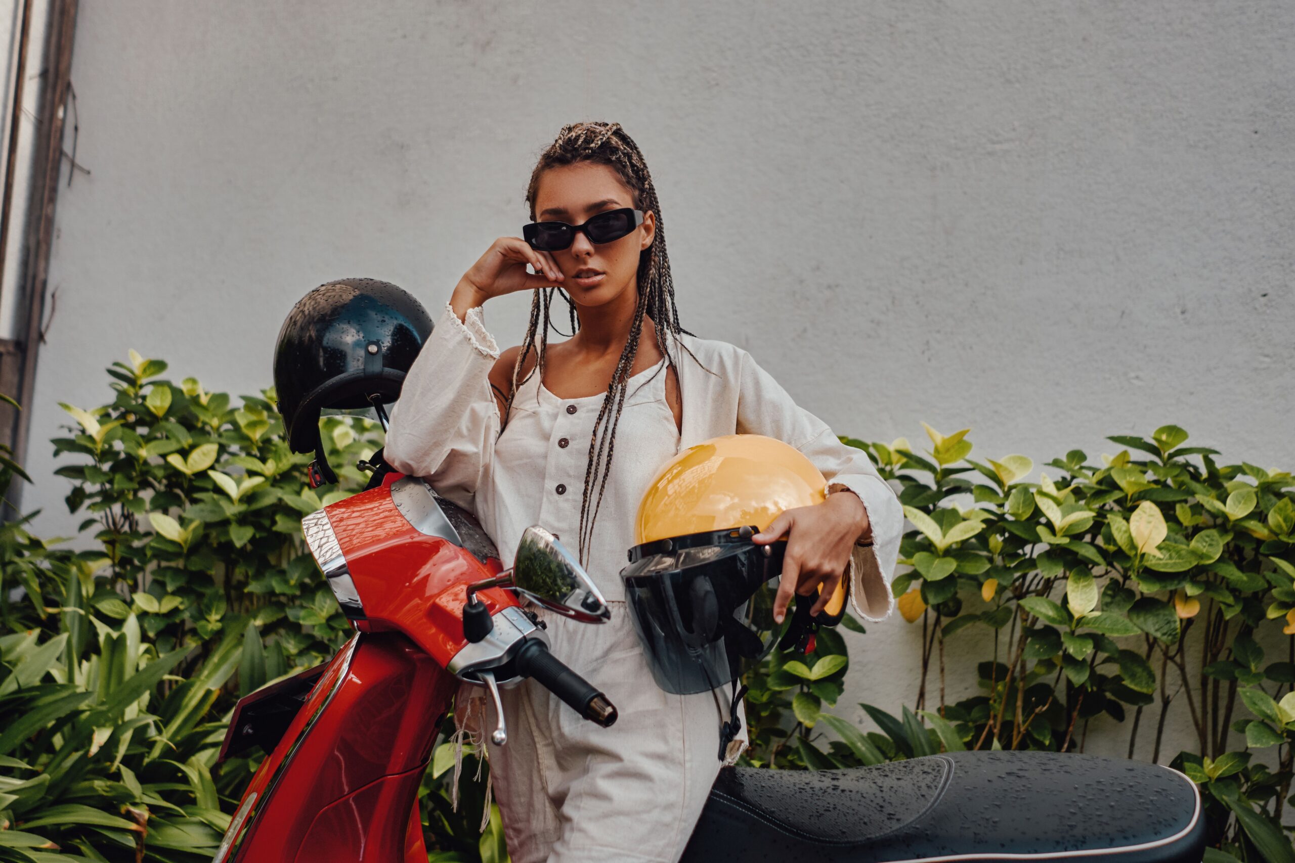 Woman with helmet and scooter outside in bali