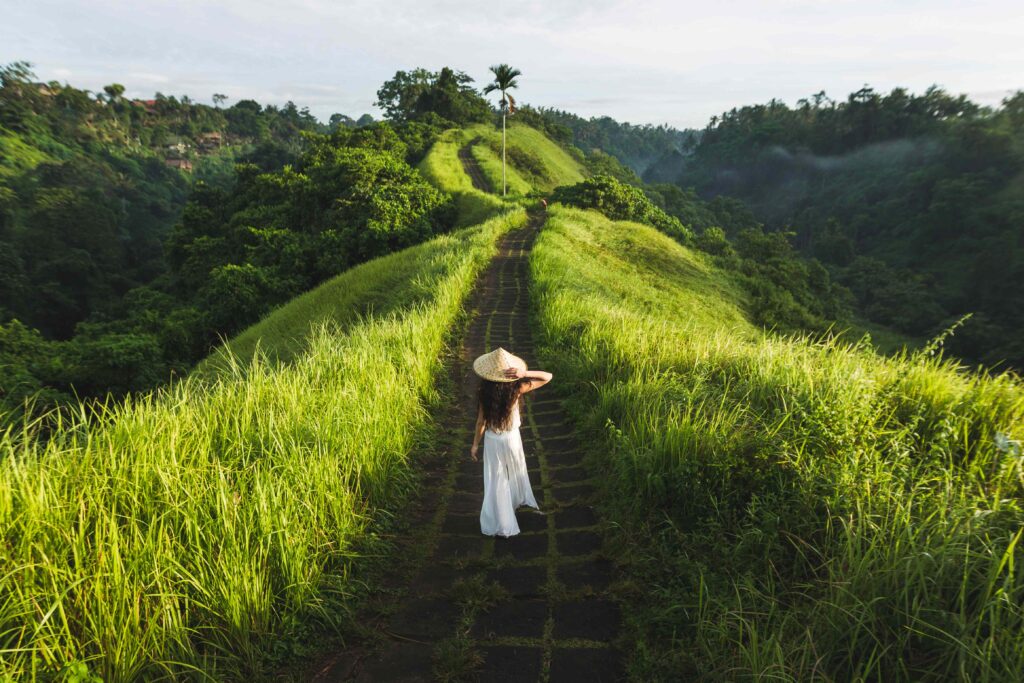 Young beautiful woman walking on Campuhan Ridge way of artists,