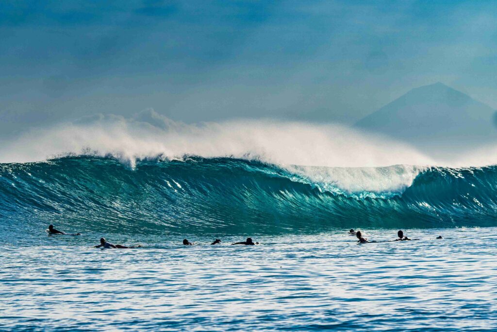 Big wave coming and many surfers waiting to catch it