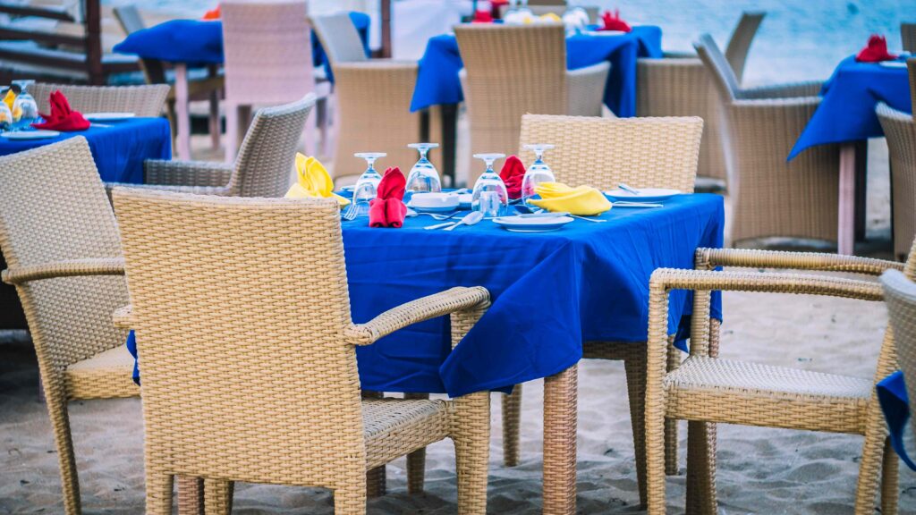 Cafe Table on a tropical sandy beach with sea on background, Nusa Dua, Bali