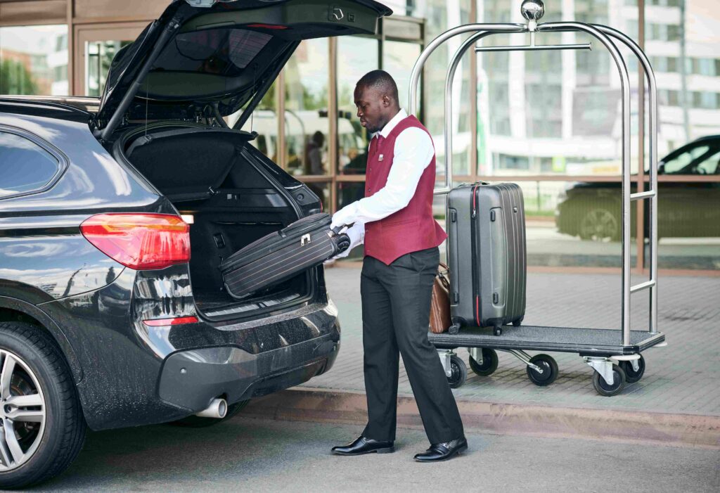 Doorman taking the suitcases out of the car