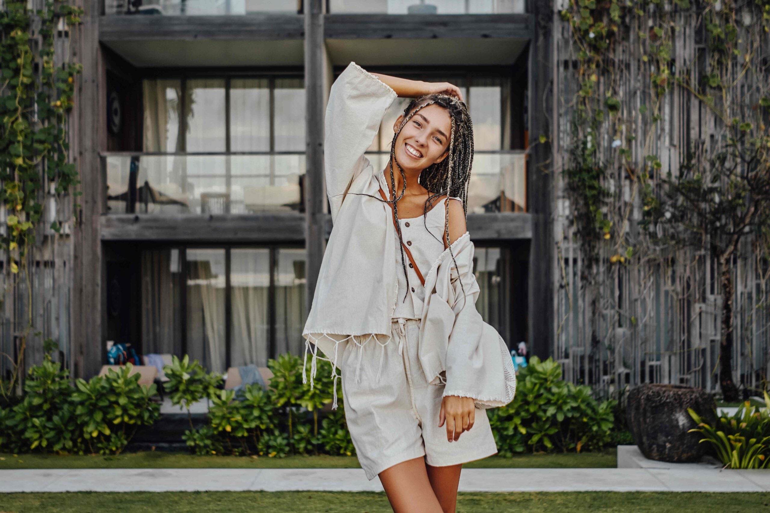 Happy woman in bali posing against mansion