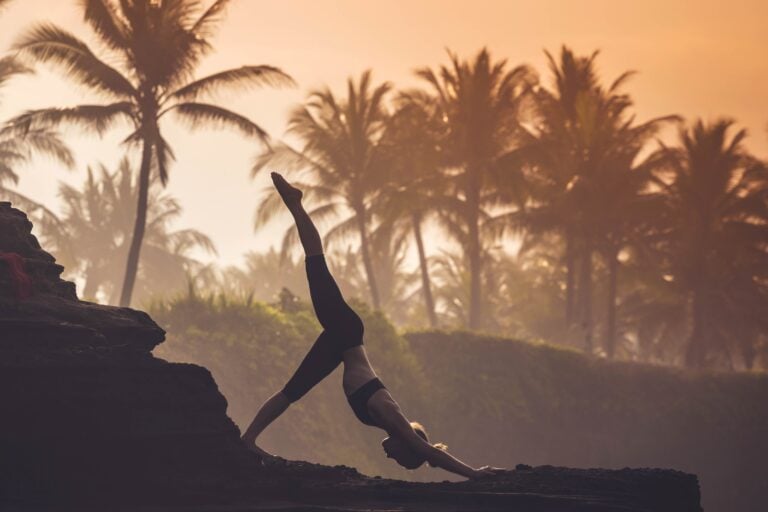 Indonesia, Bali, woman practising yoga at the coast at twilight