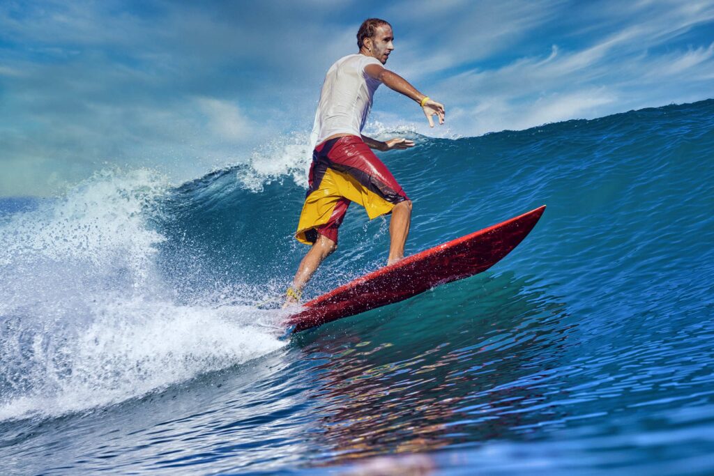 Male surfer on a blue wave