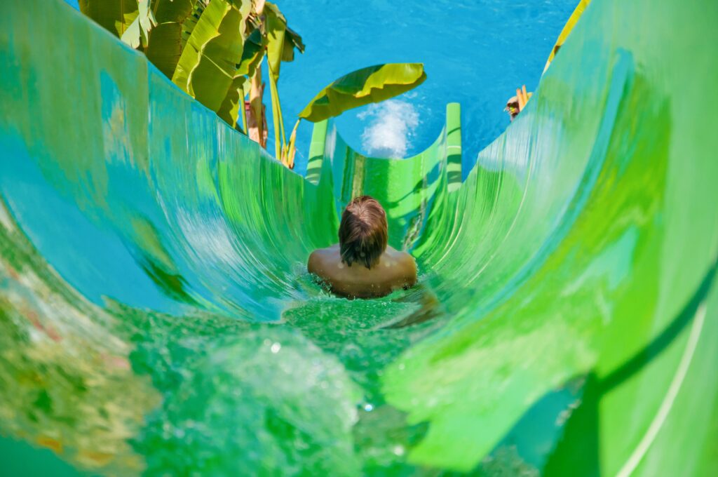 man sliding going down on a water slide in the poo 2023 11 27 05 18 50 utc