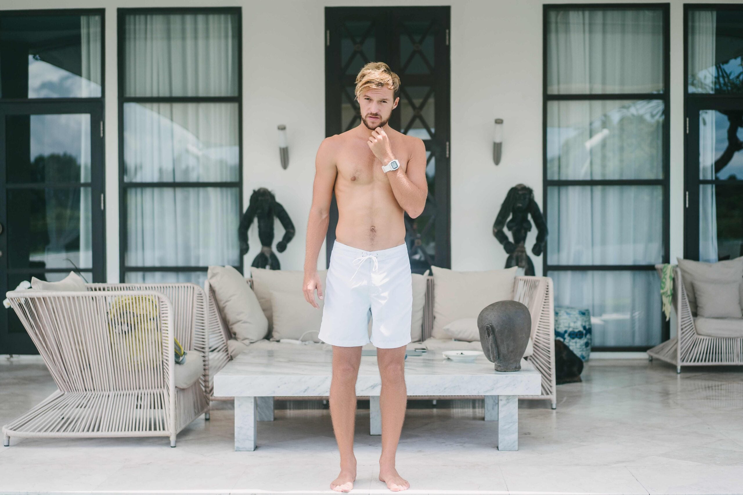 shirtless muscular man standing near hotel at resort in Bali, Indonesia