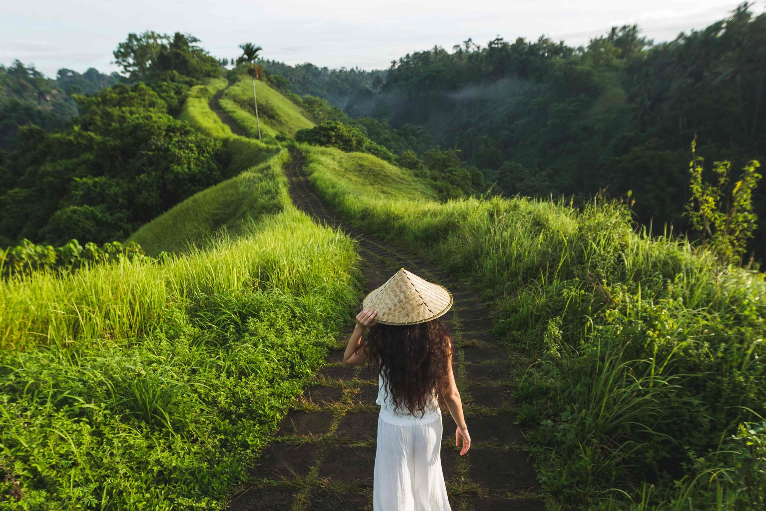 Young beautiful woman walking on Campuhan Ridge way of artists,