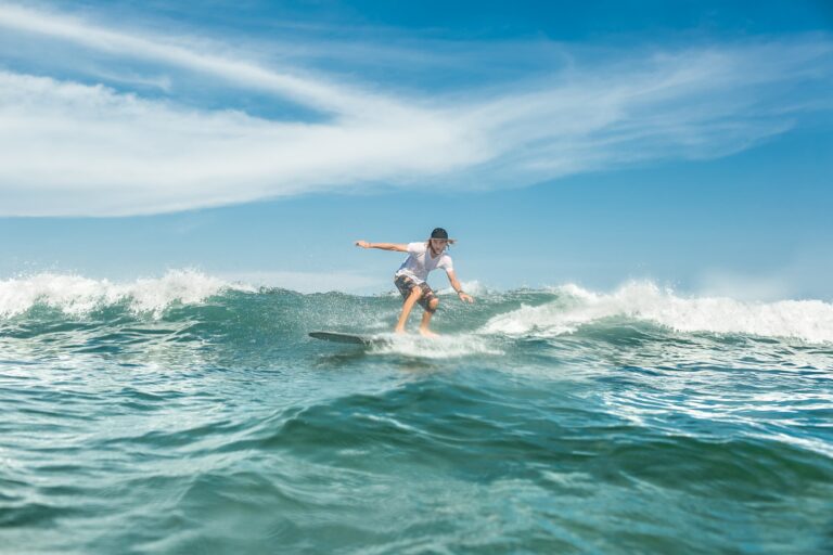 young male surfer riding in ocean at Nusa Dua Beach, Bali, Indonesia