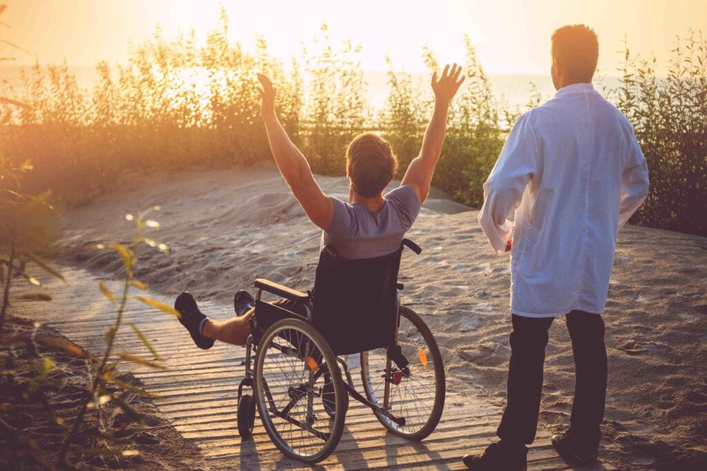 A man on wheelchair and his nurse