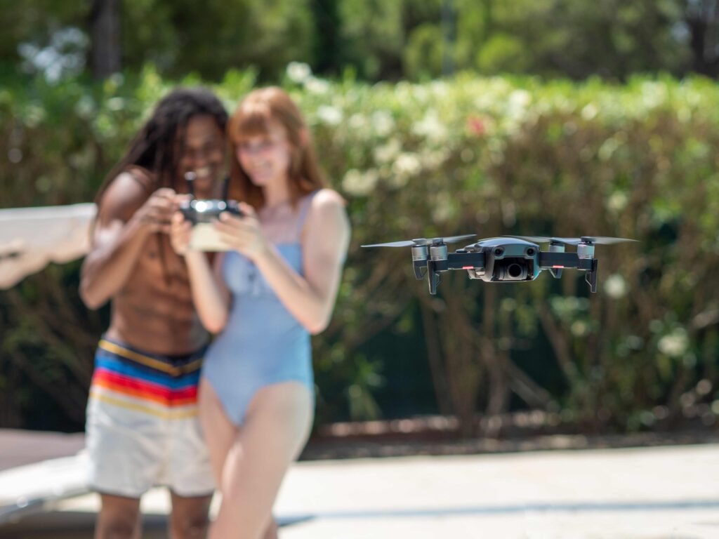 interracial couple in love, plays flying a drone