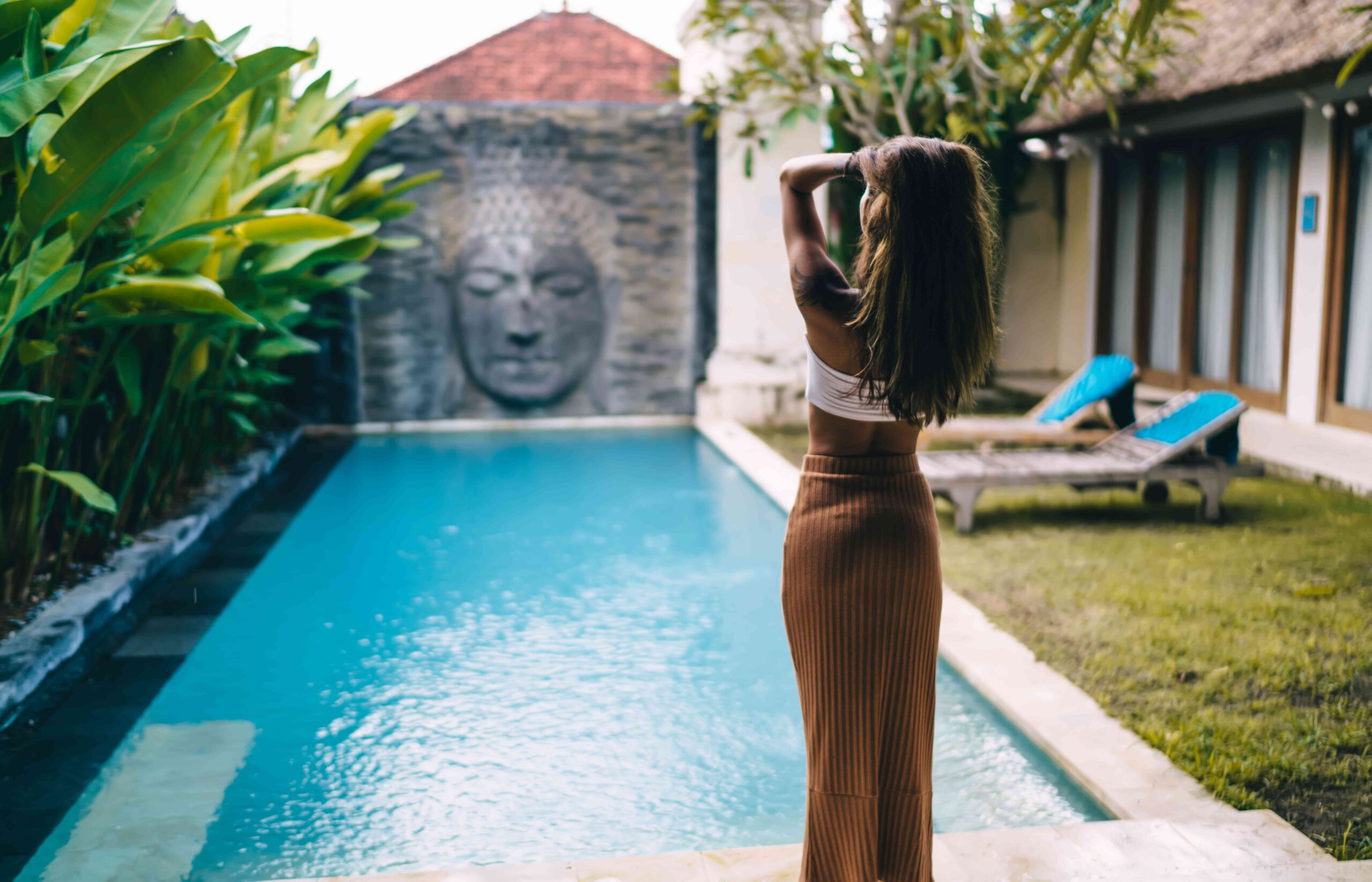 Slim woman resting outdoor near pool