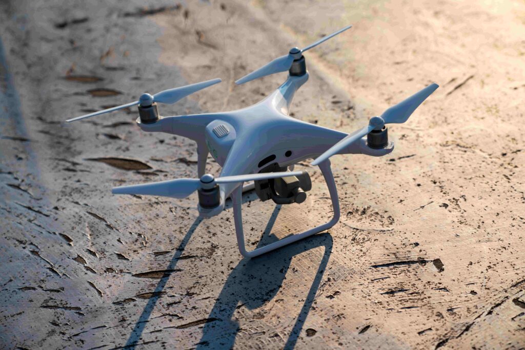 White drone quadcopter with digital camera outdoors