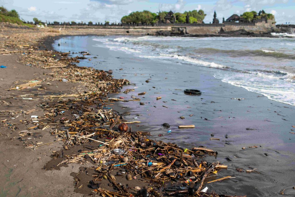 Beach pollution near famous Tanah Lot temple in Bali