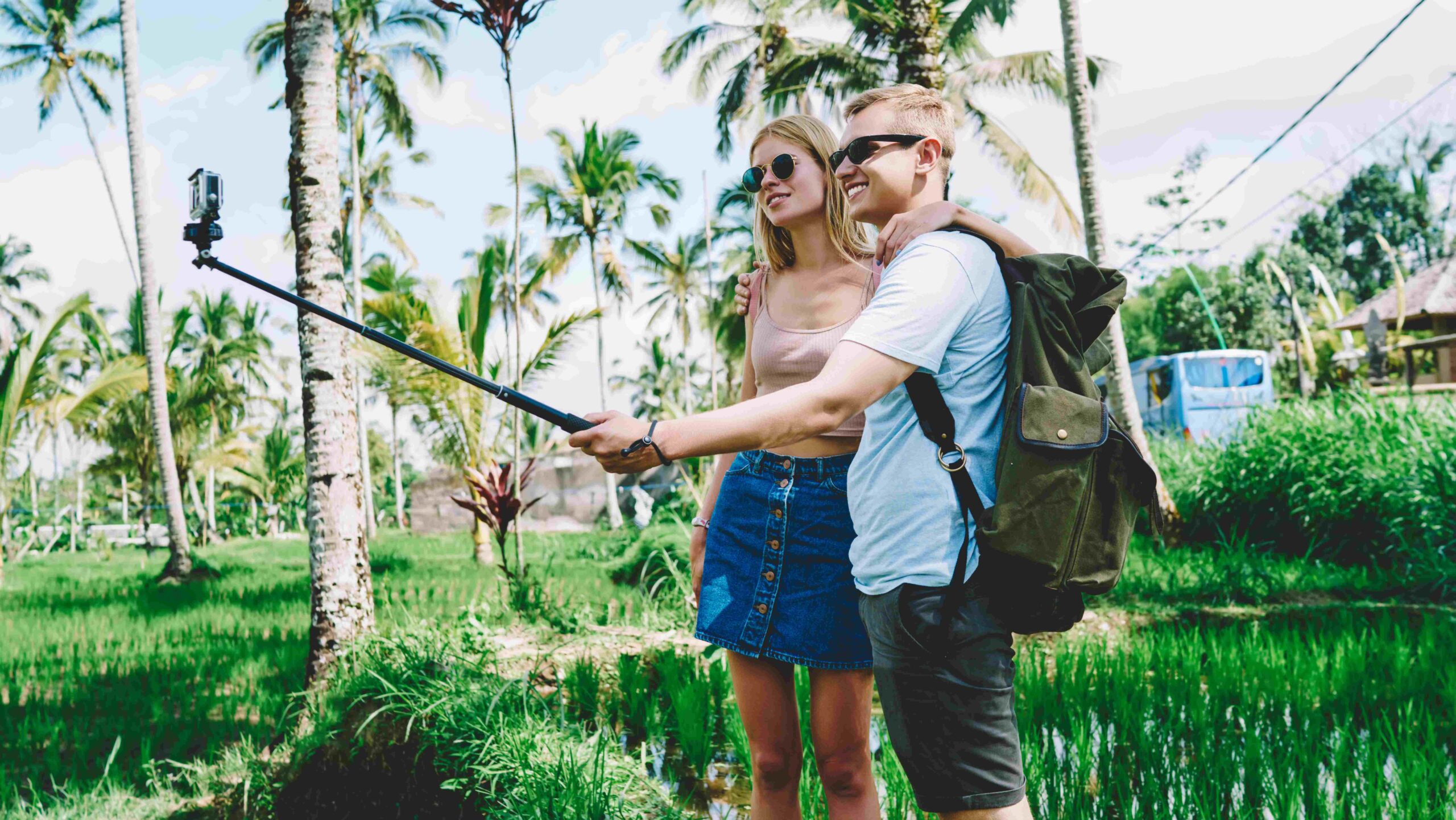 Cheerful couple taking photo in sunny day