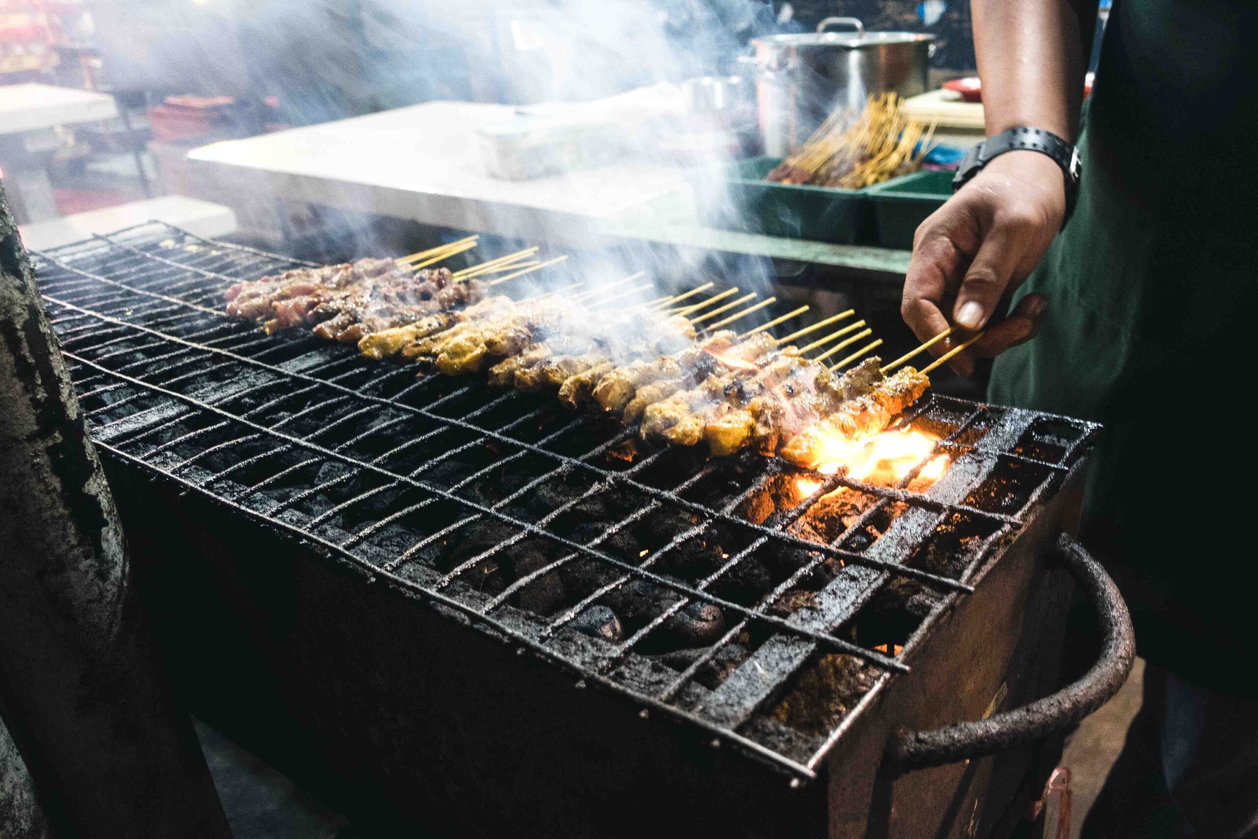 Grilling chicken satay