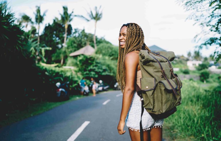 happy dark skinned woman with travel rucksack expl 2023 12 08 19 22 39 utc