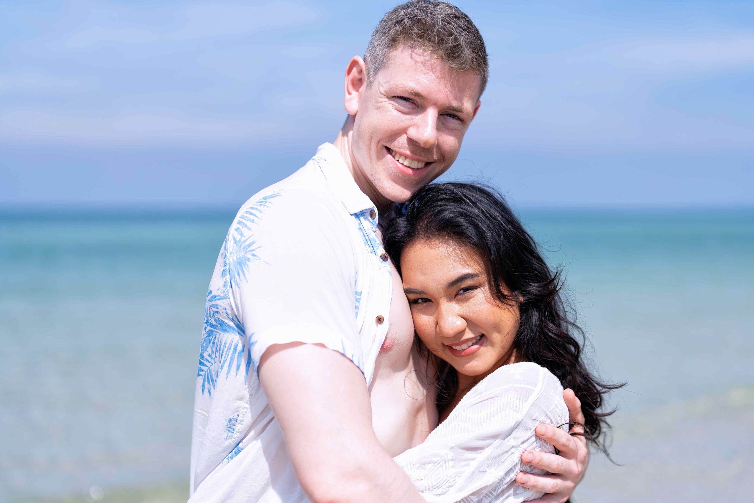 Love couple on holiday happy playing running along the beach and sweet kiss on love emotion