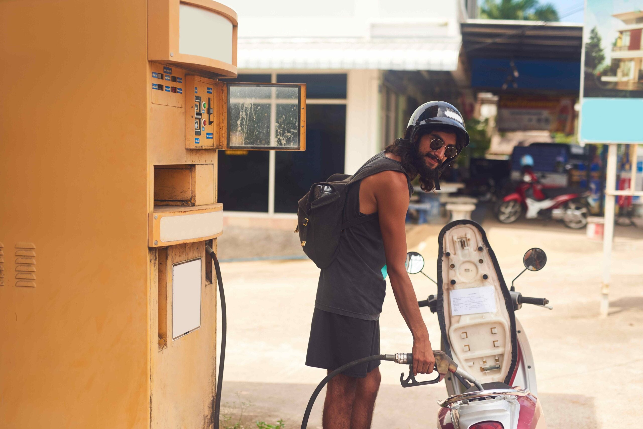 shot of a young tourist refueling his scooter at a 2023 11 27 04 49 54 utc