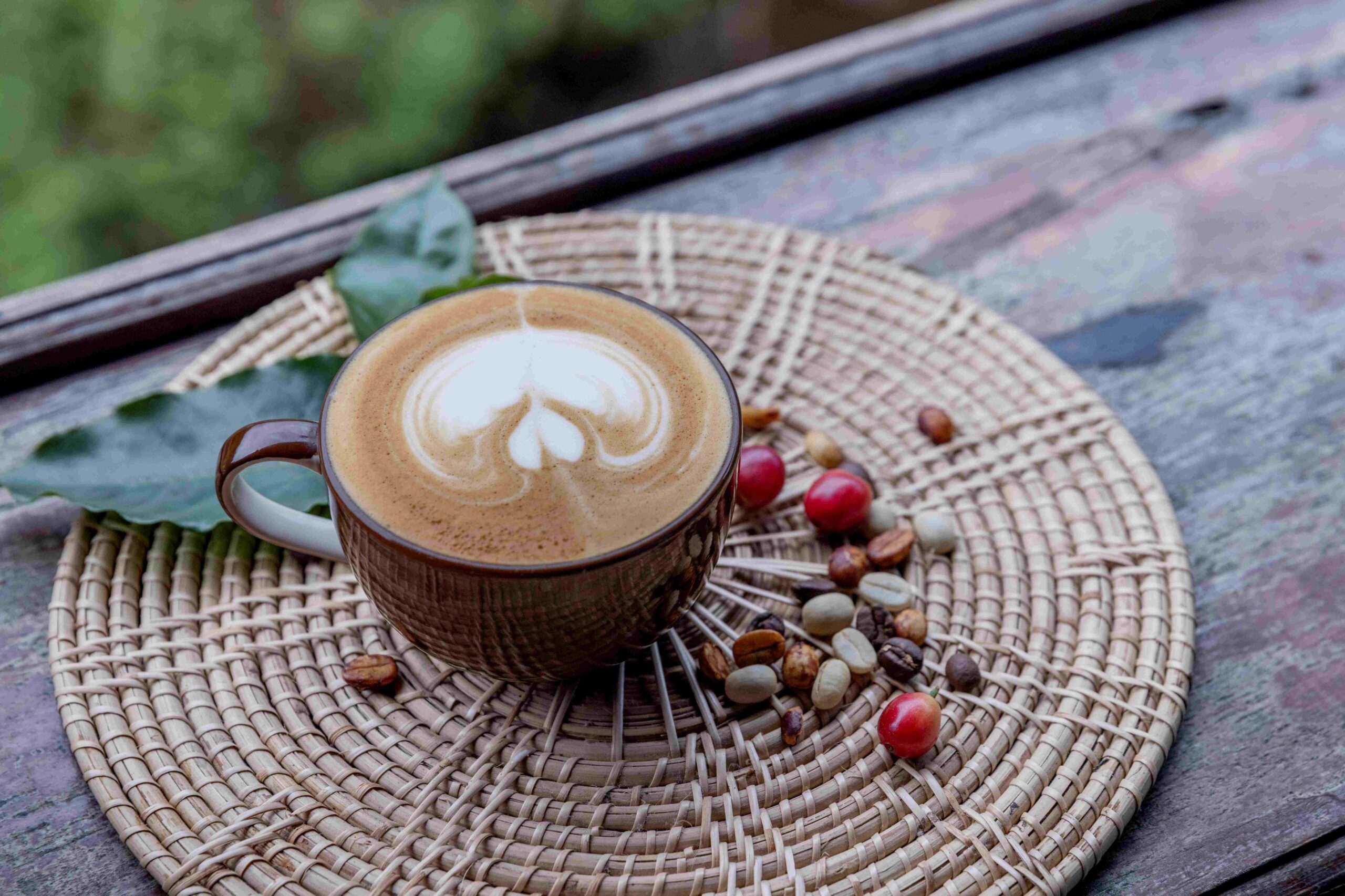 cup of coffee with coffee bean on the wood background