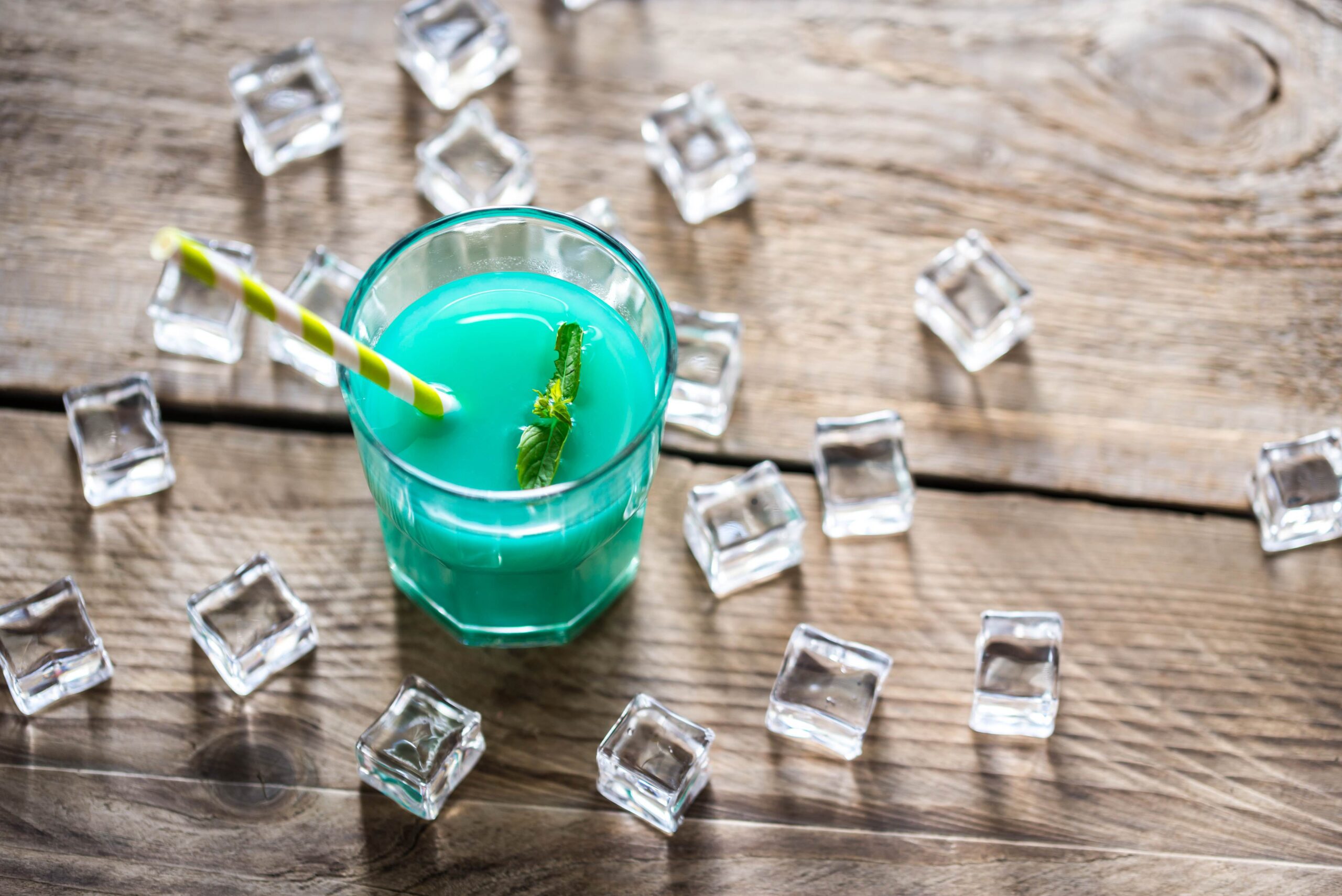 Glass of blue curacao and juice cocktail