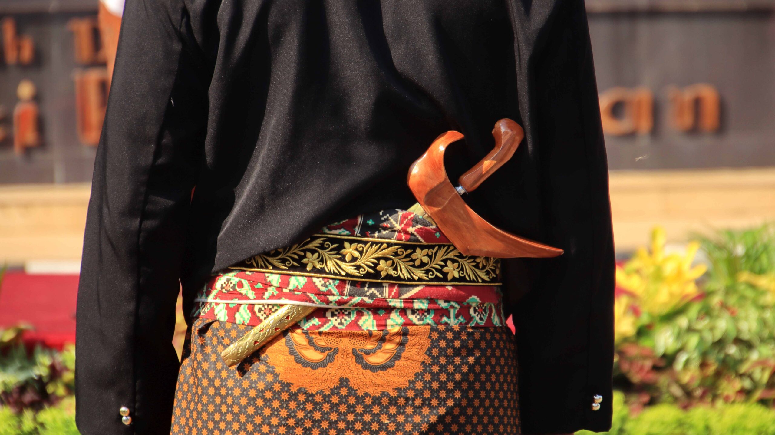 Men wearing traditional Javanese attire with keris