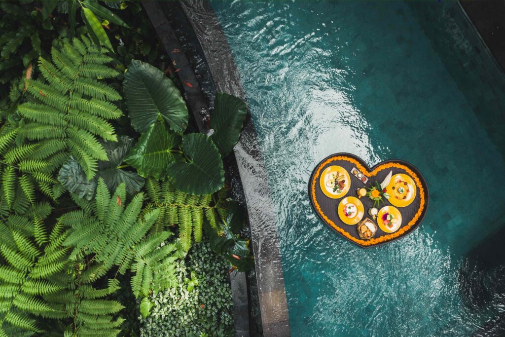 Floating breakfast in jungle swimming pool, tropical resort Bla