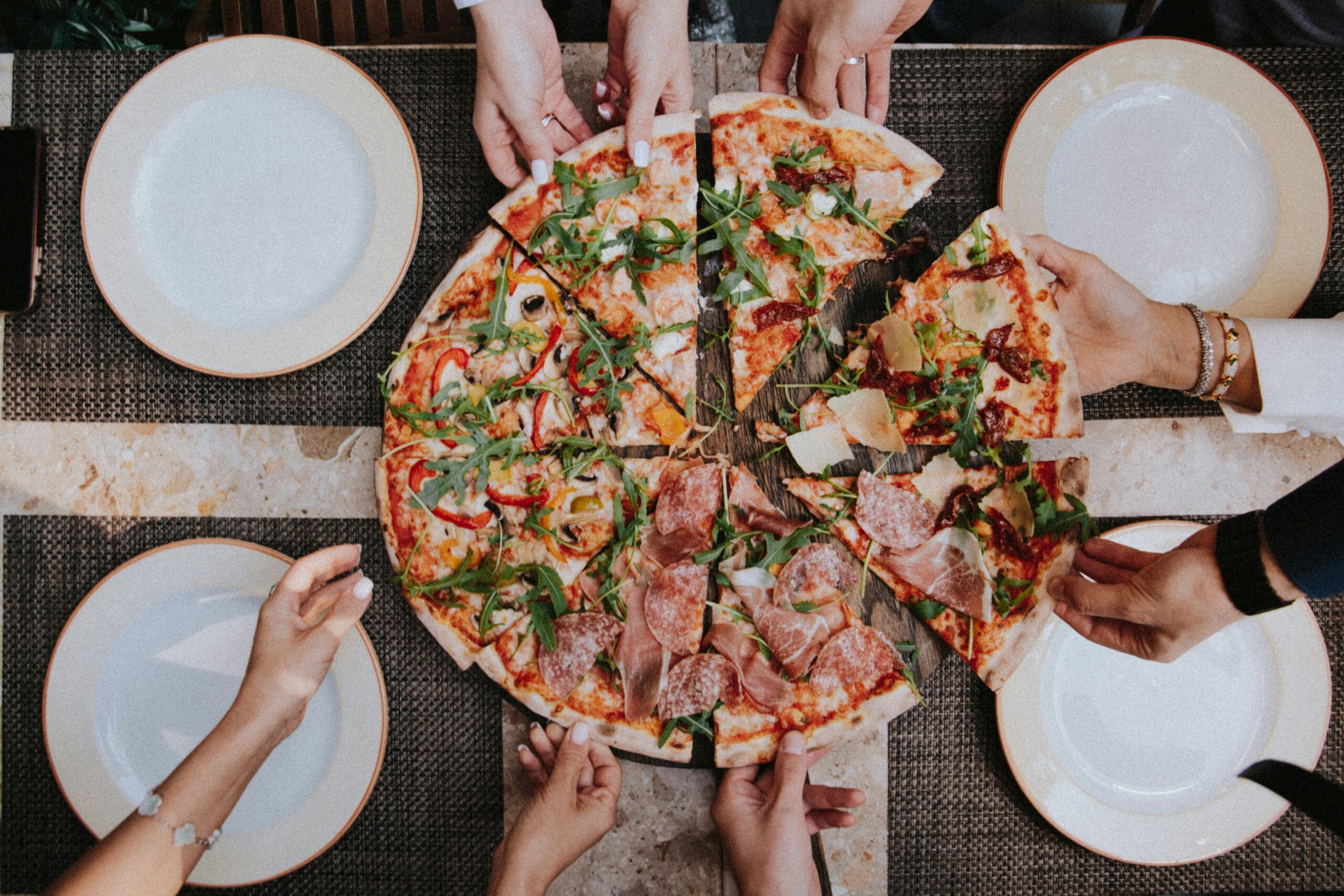 Folks bonding over pizza