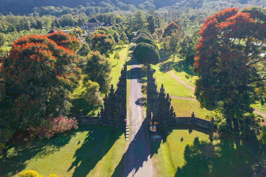 Aerial view of Bali Handara The Hindu Temple with ancient gate with pathway in park garden at noon Hindu architecture landscape background of travel trip and holidays vacation in Indonesia