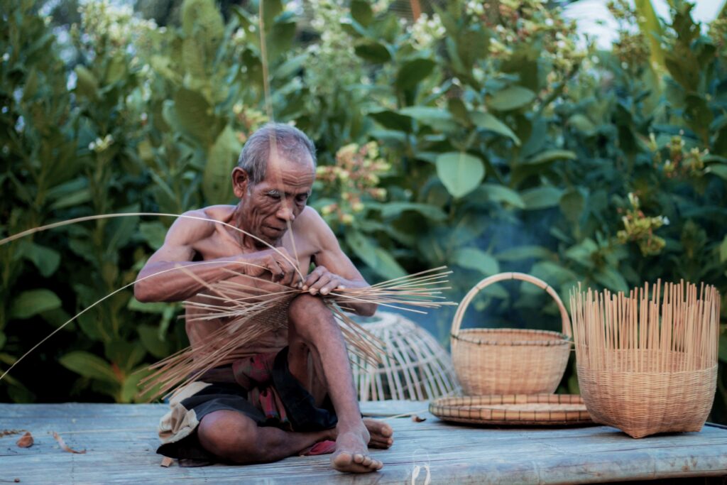 Old man are weaving basket in rural