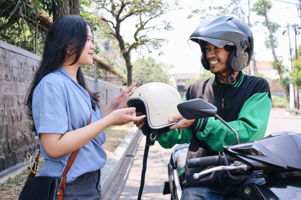 online driver giving helmet to passanger 2023 11 27 05 11 57 utc