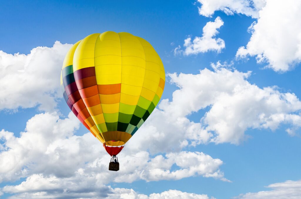Colorful hot air balloon flying over the blue sky