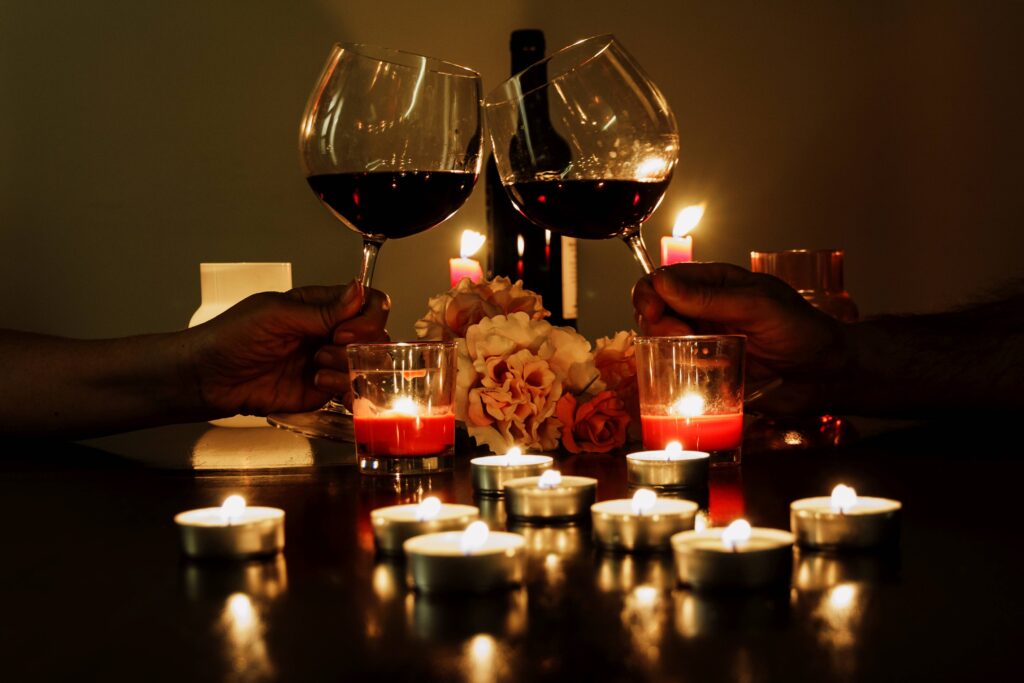 couple toasting with red wine candlelight romant 2023 11 27 05 01 34 utc